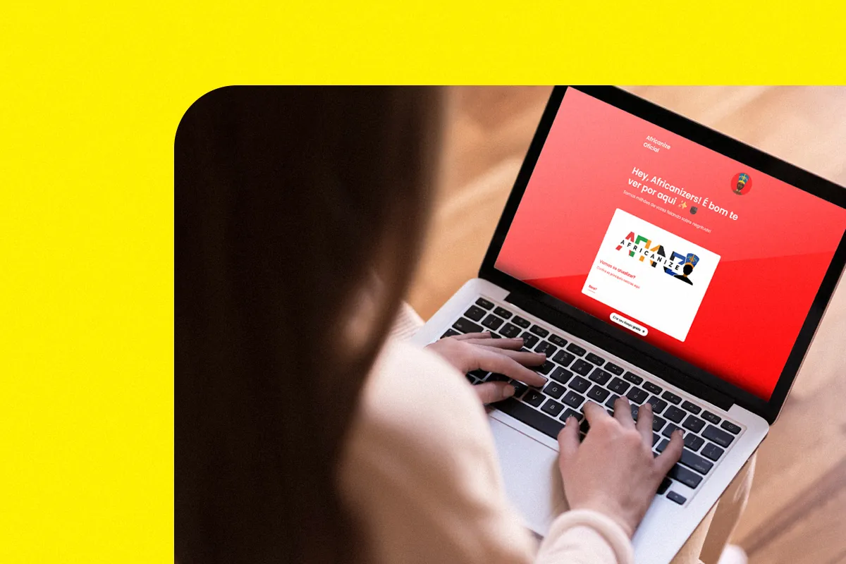 Woman typing on a laptop displaying a red link-in-bio page, against a yellow background